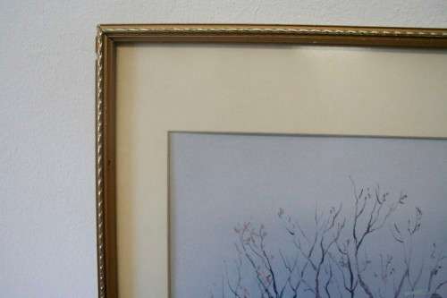 **RS17** A beautiful signed "Ted Hoefsloot" print framed behind glass of a scene of houses.