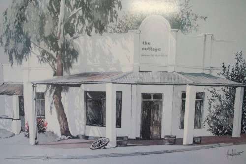 **RS17** A beautiful signed "Ted Hoefsloot" print framed behind glass of The cottage..
