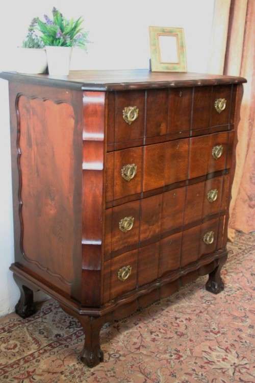 An exquisite vintage Imbuia 4-drawer chest of drawers with ornate handles and ample storage space