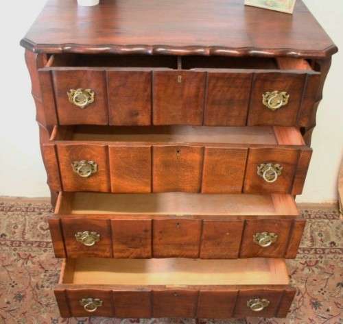 An exquisite vintage Imbuia 4-drawer chest of drawers with ornate handles and ample storage space