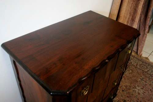 An exquisite vintage Imbuia 4-drawer chest of drawers with ornate handles and ample storage space