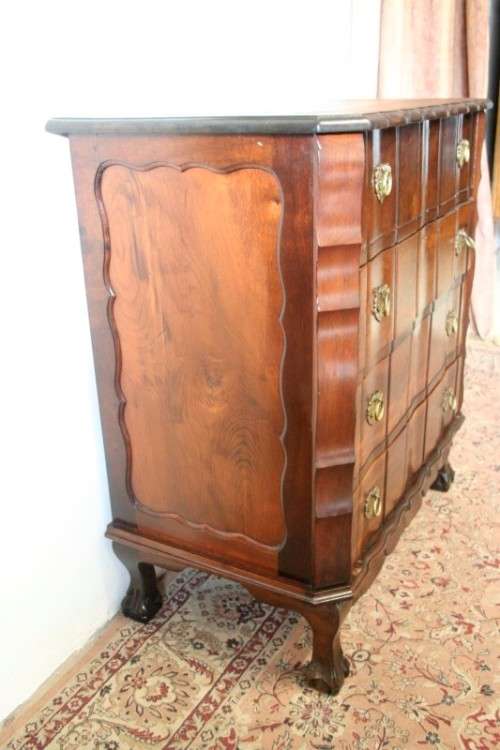 An exquisite vintage Imbuia 4-drawer chest of drawers with ornate handles and ample storage space