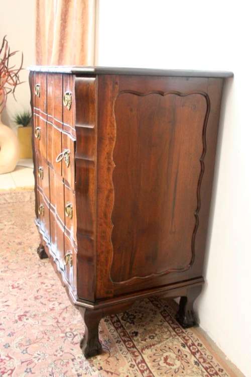 An exquisite vintage Imbuia 4-drawer chest of drawers with ornate handles and ample storage space