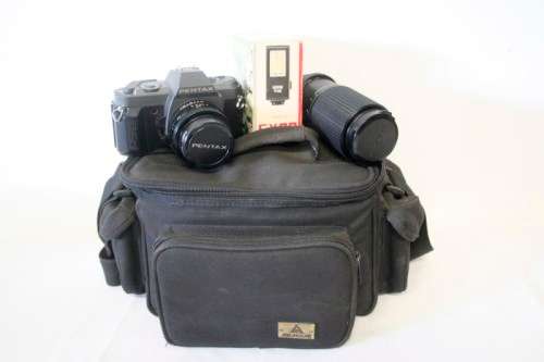 **RS17** A Pentax P30T with a Tokina Sunny 52mm lens and GX20 flash in a camera bag