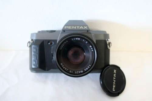 **RS17** A Pentax P30T with a Tokina Sunny 52mm lens and GX20 flash in a camera bag