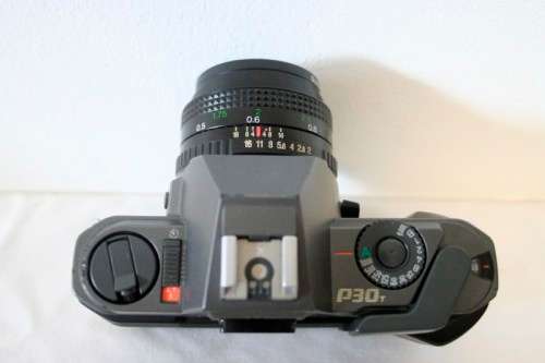 **RS17** A Pentax P30T with a Tokina Sunny 52mm lens and GX20 flash in a camera bag