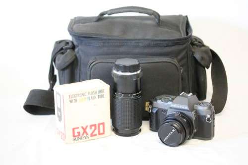 **RS17** A Pentax P30T with a Tokina Sunny 52mm lens and GX20 flash in a camera bag