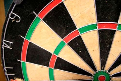 A top quality Unicorn (Phil Taylor)dart board in a wooden cabinet w score boards in super condition.