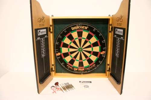 A top quality Unicorn (Phil Taylor)dart board in a wooden cabinet w score boards in super condition.