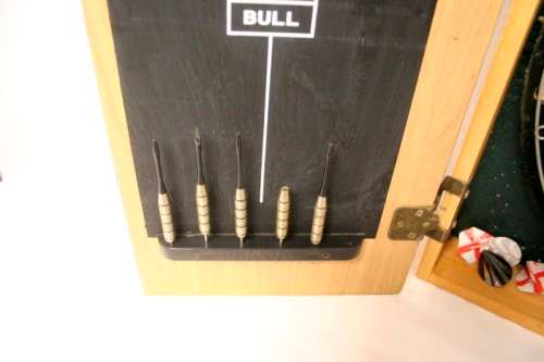 A top quality Unicorn (Phil Taylor)dart board in a wooden cabinet w score boards in super condition.
