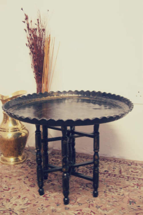 A fabulous Moroccan etched copper tray (w a paint technique) folding table with a wood base.