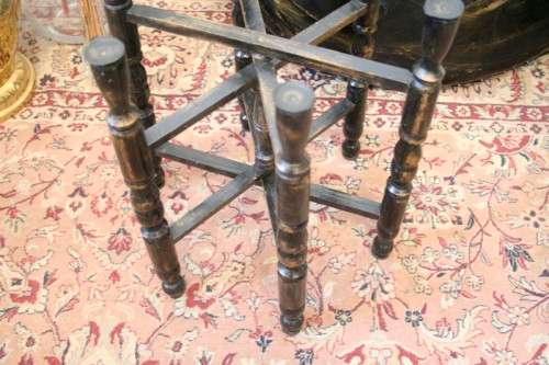 A fabulous Moroccan etched copper tray (w a paint technique) folding table with a wood base.