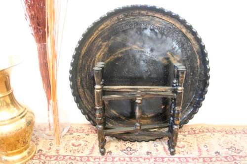 A fabulous Moroccan etched copper tray (w a paint technique) folding table with a wood base.