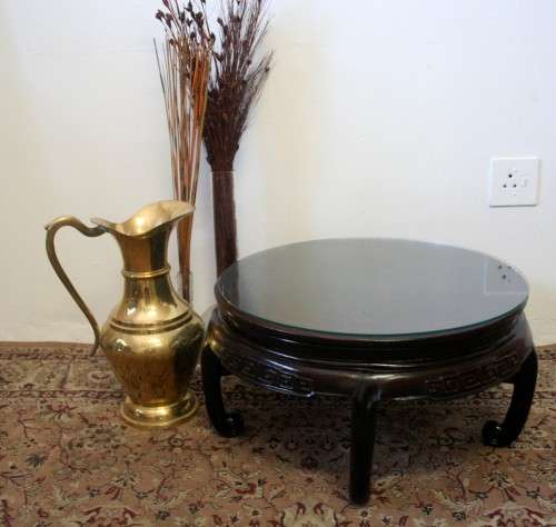 A superb round Chinese Ming style coffee table with carved detailing and glass top.