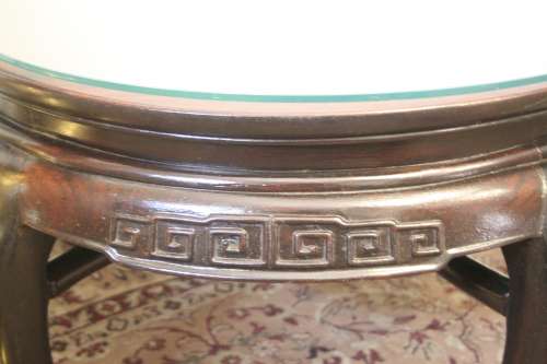 A superb round Chinese Ming style coffee table with carved detailing and glass top.
