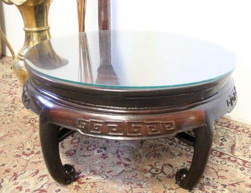 A superb round Chinese Ming style coffee table with carved detailing and glass top.