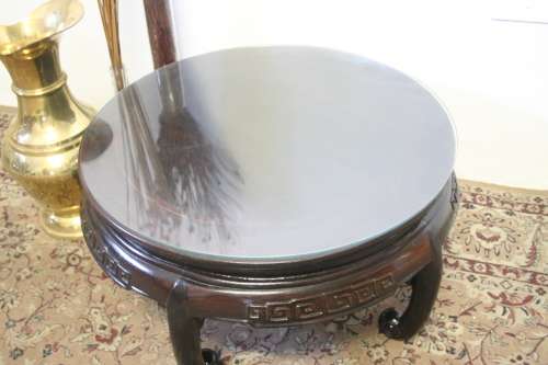 A superb round Chinese Ming style coffee table with carved detailing and glass top.