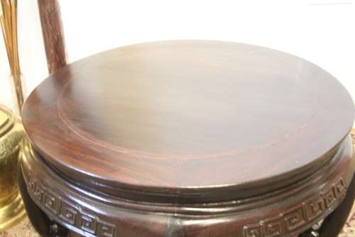 A superb round Chinese Ming style coffee table with carved detailing and glass top.