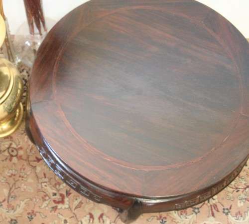 A superb round Chinese Ming style coffee table with carved detailing and glass top.