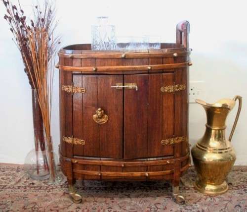 A unique antique Oak drinks trolley cabinet with brass embellishments and original castors.