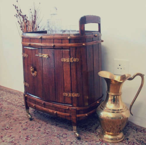 A unique antique Oak drinks trolley cabinet with brass embellishments and original castors.