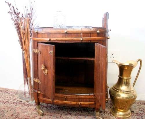 A unique antique Oak drinks trolley cabinet with brass embellishments and original castors.