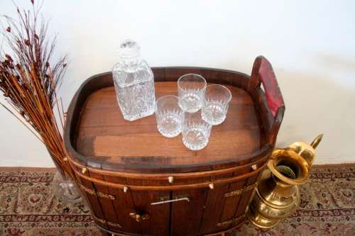 A unique antique Oak drinks trolley cabinet with brass embellishments and original castors.