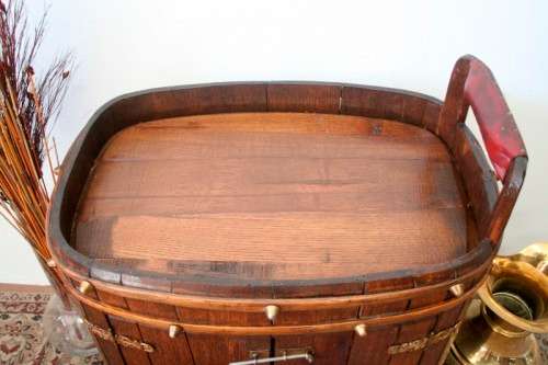 A unique antique Oak drinks trolley cabinet with brass embellishments and original castors.