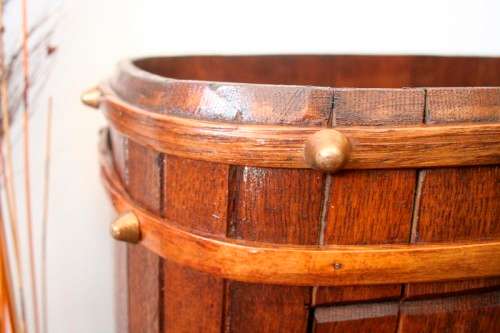 A unique antique Oak drinks trolley cabinet with brass embellishments and original castors.