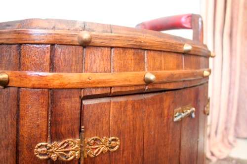 A unique antique Oak drinks trolley cabinet with brass embellishments and original castors.