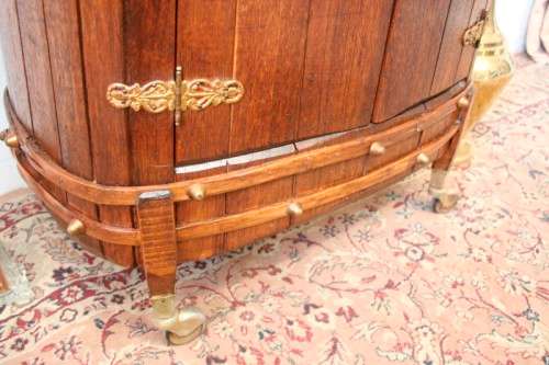 A unique antique Oak drinks trolley cabinet with brass embellishments and original castors.
