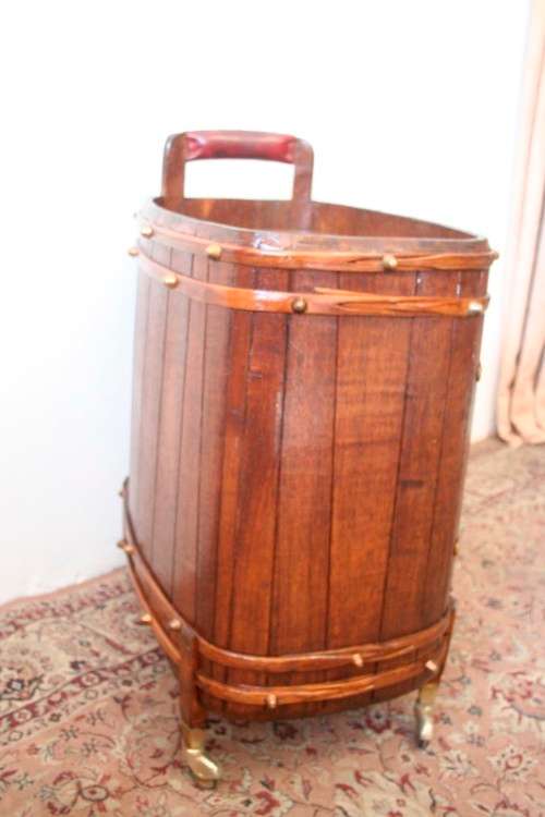 A unique antique Oak drinks trolley cabinet with brass embellishments and original castors.