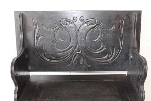 A superb antique hand-carved blackened oak monks bench with a storage chest in the base