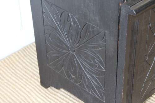 A superb antique hand-carved blackened oak monks bench with a storage chest in the base