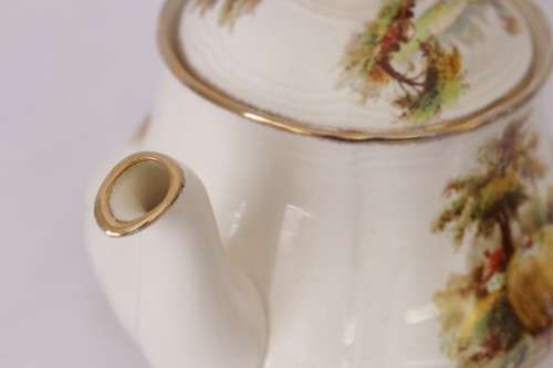 A gorgeous vintage Alfred Meakin ivory-porcelain 4-cup teapot with beautiful country scene detailing