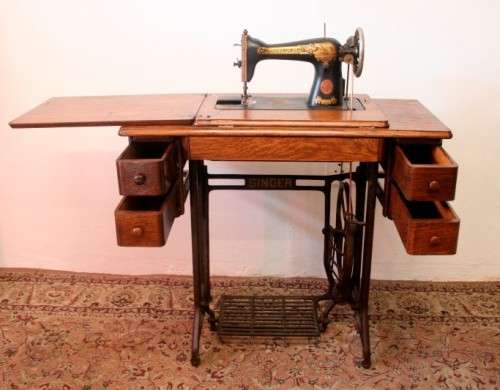 A spectacular 1933 Singer treadle sewing machine in its original Oak cabinet in wonderful condition