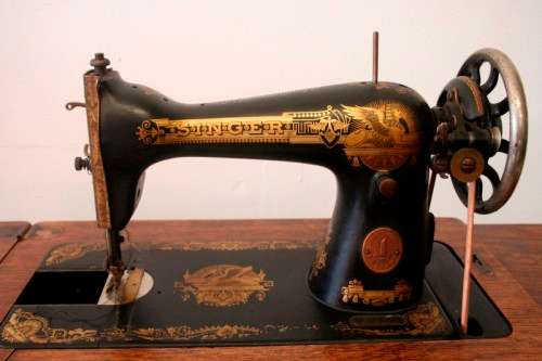 A spectacular 1933 Singer treadle sewing machine in its original Oak cabinet in wonderful condition