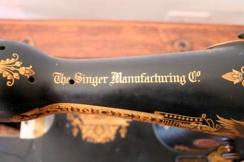 A spectacular 1933 Singer treadle sewing machine in its original Oak cabinet in wonderful condition