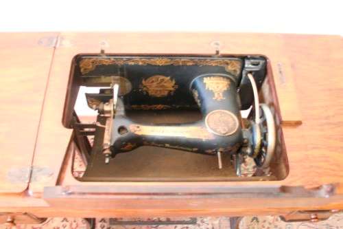 A spectacular 1933 Singer treadle sewing machine in its original Oak cabinet in wonderful condition
