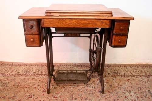 A spectacular 1933 Singer treadle sewing machine in its original Oak cabinet in wonderful condition