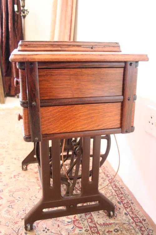 A spectacular 1933 Singer treadle sewing machine in its original Oak cabinet in wonderful condition
