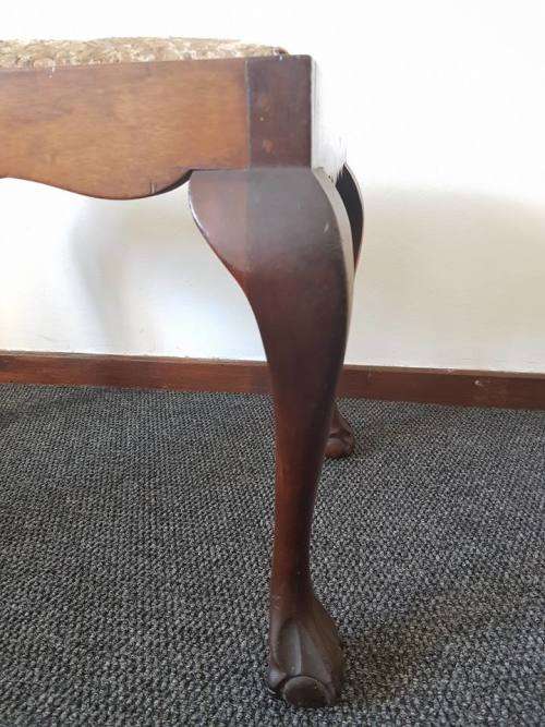A beautiful and elegant vintage solid imbuia piano stool/ bench with carved ball and claw feet.