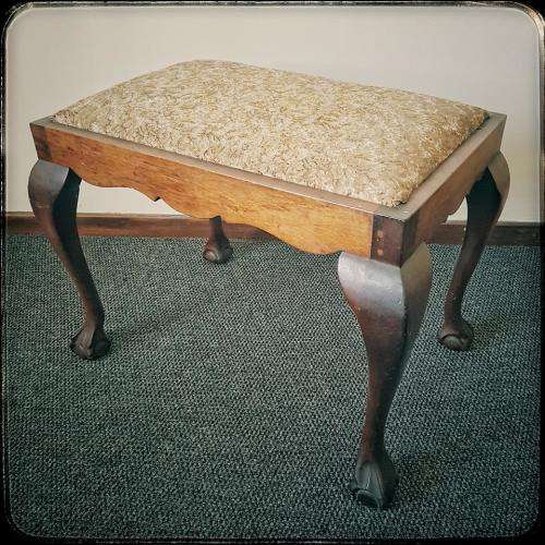 A beautiful and elegant vintage solid imbuia piano stool/ bench with carved ball and claw feet.