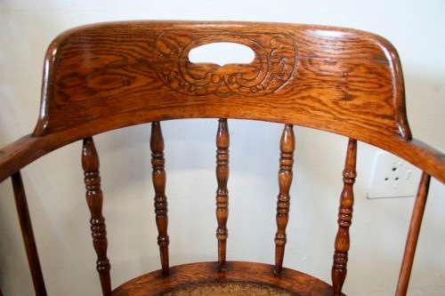 A superb antique oak captains swivel desk chair with a rattan seat in very good condition.