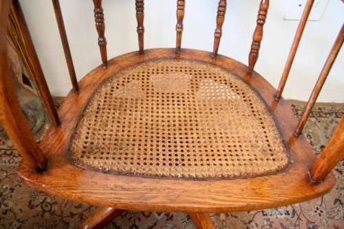 A superb antique oak captains swivel desk chair with a rattan seat in very good condition.