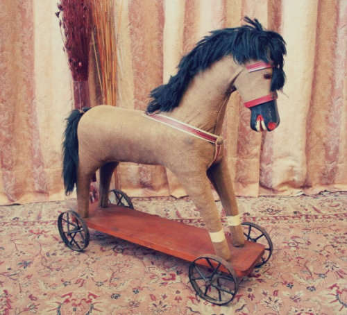 A stunning RARE antique pull toy horse on wheels in good condition - wow!!
