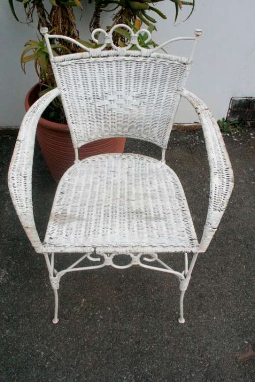 A wonderful white wicker table with a glass top and a chair all weather outdoor/ patio set.
