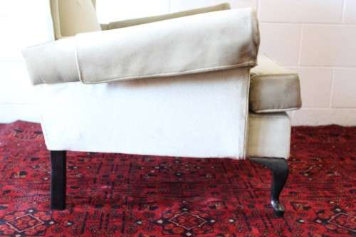 An awesome Queen Anne button-back wing-back armchair in a pale green velvet with arm covers