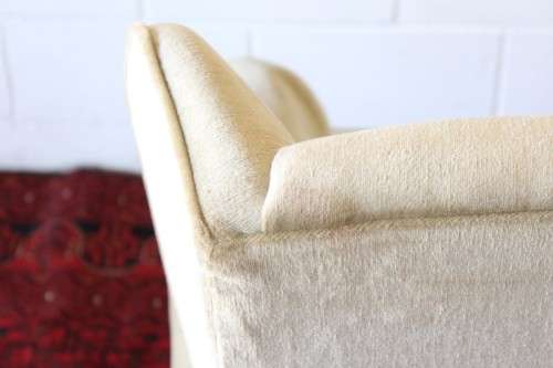 An awesome Queen Anne button-back wing-back armchair in a pale green velvet with arm covers