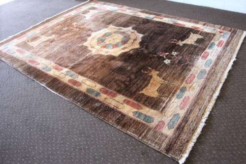 A stylish & unusual brown Iranian Meshkin Persian Carpet w/ deer motifs & centre medallion